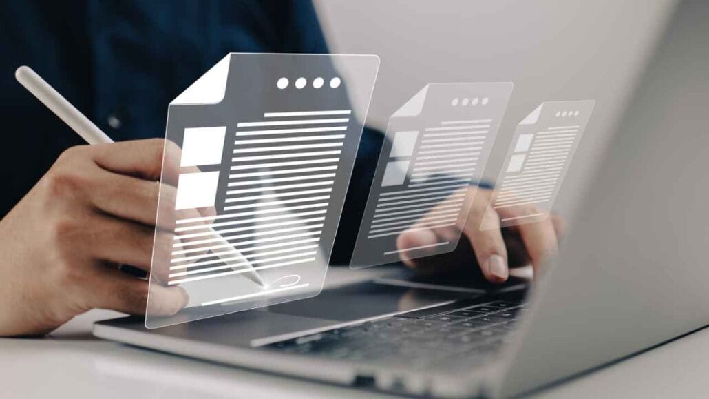 Profissional utilizando notebook e documentos digitais para elaborar laudo acústico, representando análise técnica de isolamento sonoro e emissão de relatórios